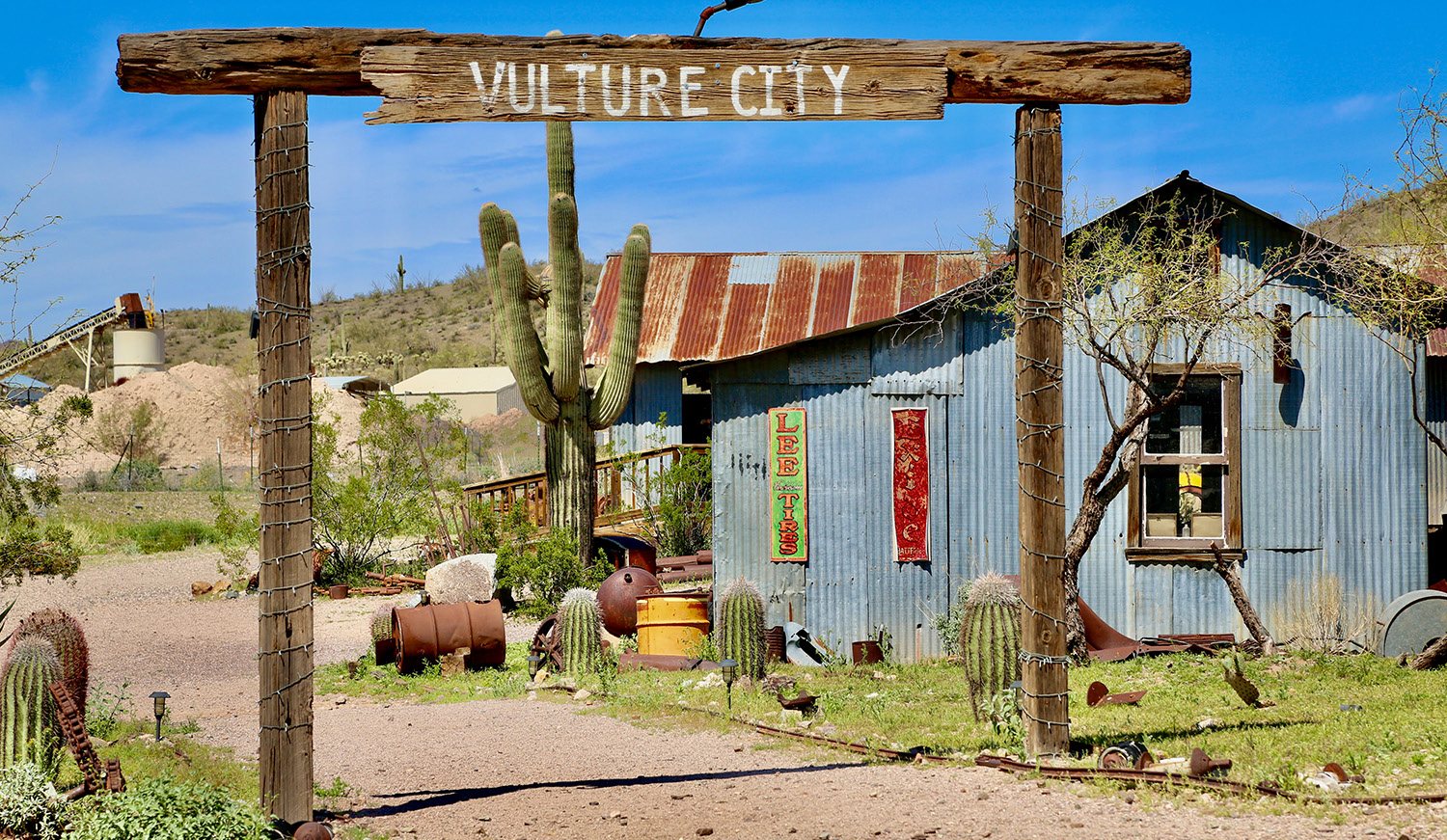 The Vulture City gate and a weathered blue miner's shack.