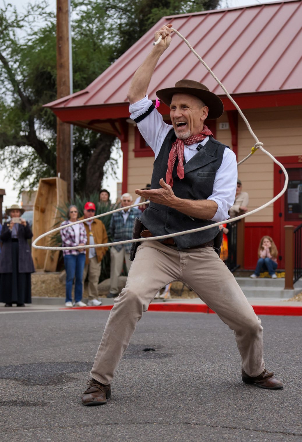 Will Roberts spinning a rope on a Wickenburg street.